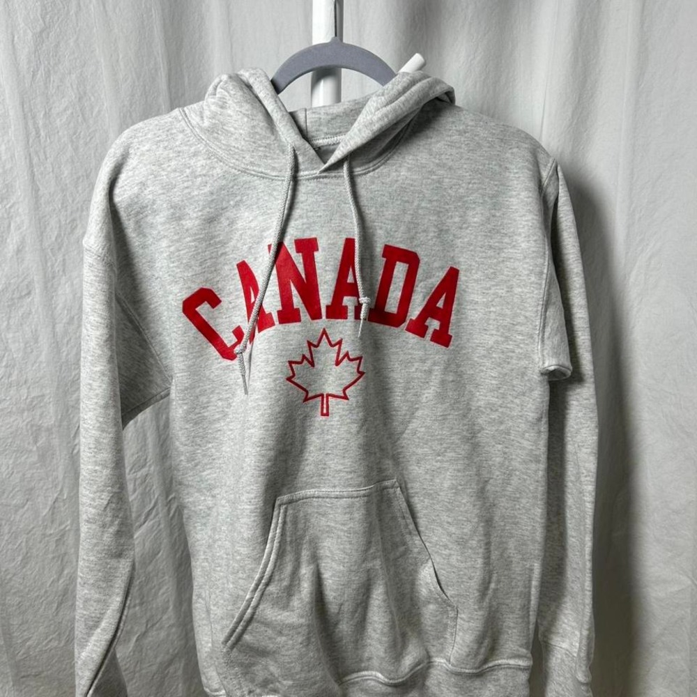 Canada pullover hoodie with a‎ red arched text and maple leaf graphic small